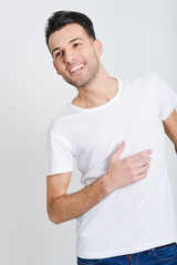 Smiling young man standing against white background