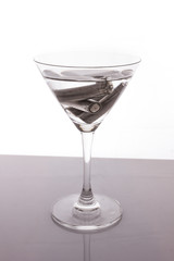 isolated of old AA battery in wine glass is energy consumption c