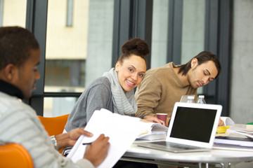 Cheerful young woman studying in the university library