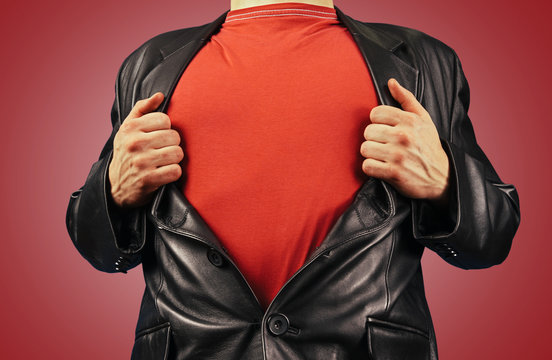 Man opens jacket showing red t-shirt