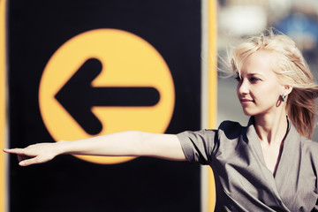 Young woman pointing a direction
