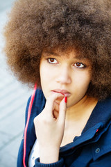 Thoughtful woman with afro hair cut
