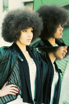 Beauty shot of a young, black woman with afro hair cut