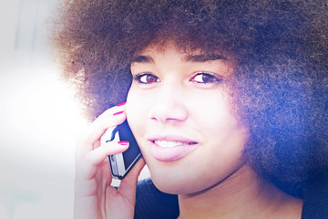 Young black, woman with smartphone and light effect