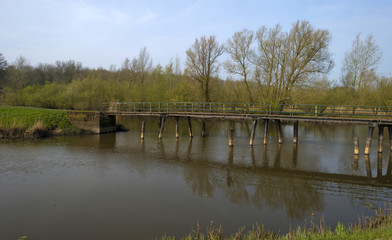 Fototapeta premium Footbridge over a river in spring