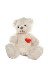 Fluffy white teddy bear with a heart on white