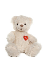 Fluffy white teddy bear with a heart on white