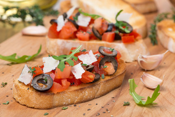 ciabatta with tomatoes, olives, parmesan cheese and herbs
