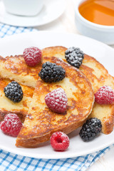 French toast with fresh berries and powdered sugar, vertical