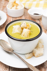 spicy zucchini soup with croutons in a cup, close-up