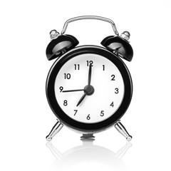 Black old style alarm clock isolated on white