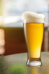 Glass of light beer in pub