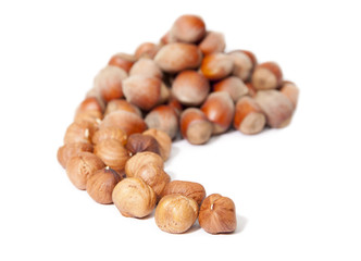 Hazelnuts and whole peeled on white background.