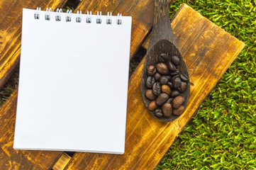 Coffee beans with spoon and note book
