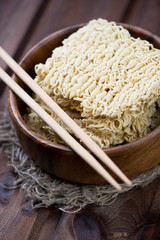 Close-up of chinese noodles with eating sticks, vertical shot