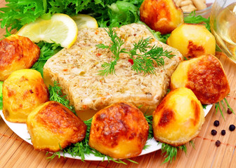 Aspic from meat with roasted potatoes and fresh herbs