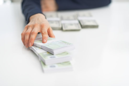 Closeup On Business Woman Giving Money Packs