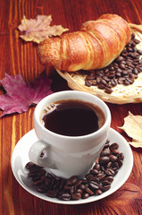 Cup of coffee and croissant