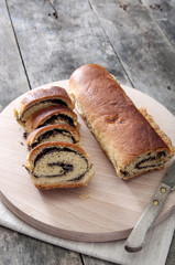 poppy seed Roll on a wooden surface
