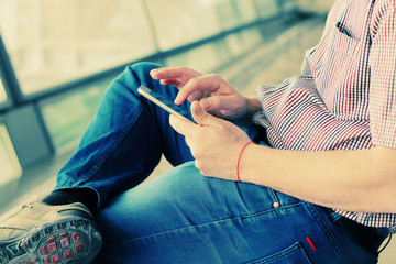 close up man's hands using tablet