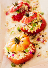 Ripe red baked tomato with savory corn filling
