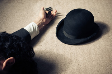 Dead man and hat on floor