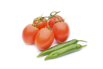 Green chili peppers with red tomatoes on the white background