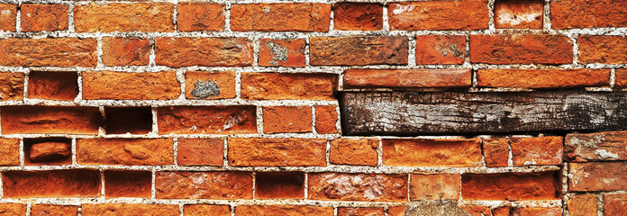 Red brick wall background texture with wooden plinth.