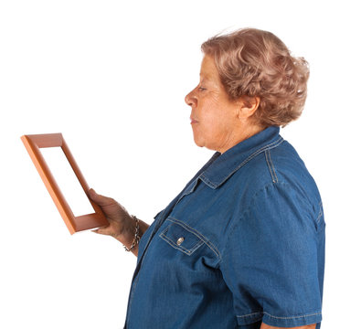 Old lady crying watching a blank photo frame