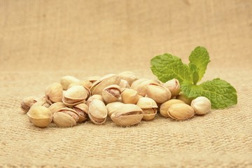 Roasted pistachios on the jute gunny bag