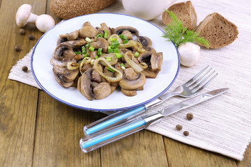 Delicious fried mushrooms on plate on table close-up
