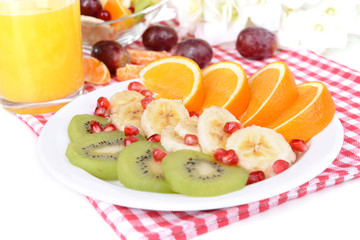 Sweet fresh fruits on plate on table close-up