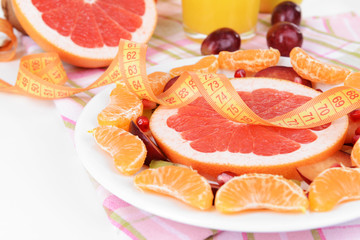 Sweet fresh fruits on plate on table close-up