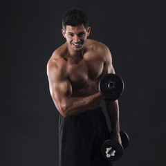 Muscular man lifting weights
