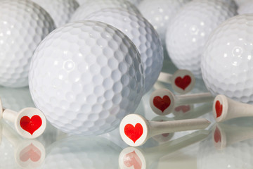 Many golf balls on a glass table