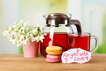 Tasty herbal tea and cookies on wooden table