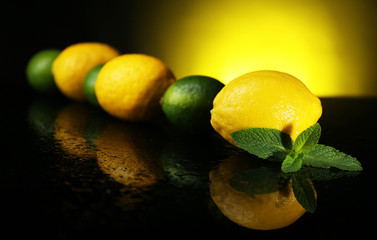 Lemons and limes on dark background