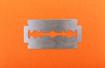 Razor blade on color background