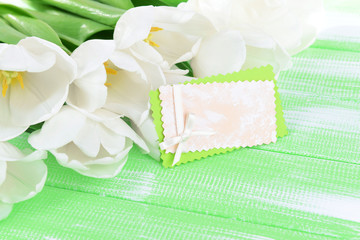 Beautiful bouquet of white tulips on light green background