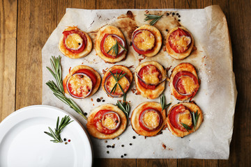 Small pizzas on baking paper close up