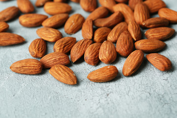 Almonds on color wooden background
