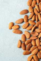 Almonds on color wooden background