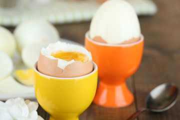 Boiled eggs on color wooden background