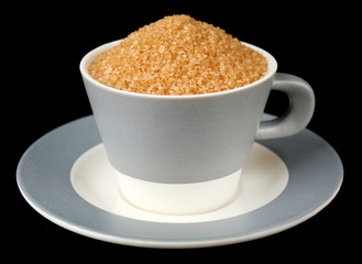 Sugar in cup isolated on black