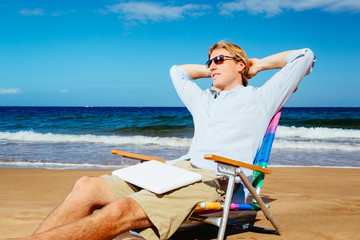 Young Attractive Casual Business Man Relaxing at the Beach with