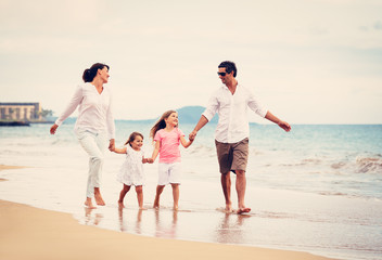 Happy Family have Fun Walking on Beach at Sunset