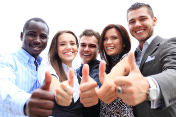 Successful young business people showing thumbs up sign