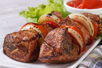 shish kebab with vegetables and sauce front view