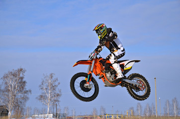 Fototapeta na wymiar Motocross racer performs a jump efficient