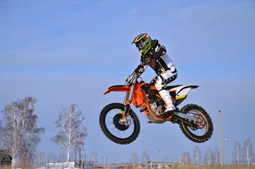 Rolgordijnen Motocross racer performs a jump efficient © VVKSAM